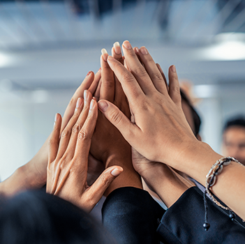 A group of hands giving each other a high five